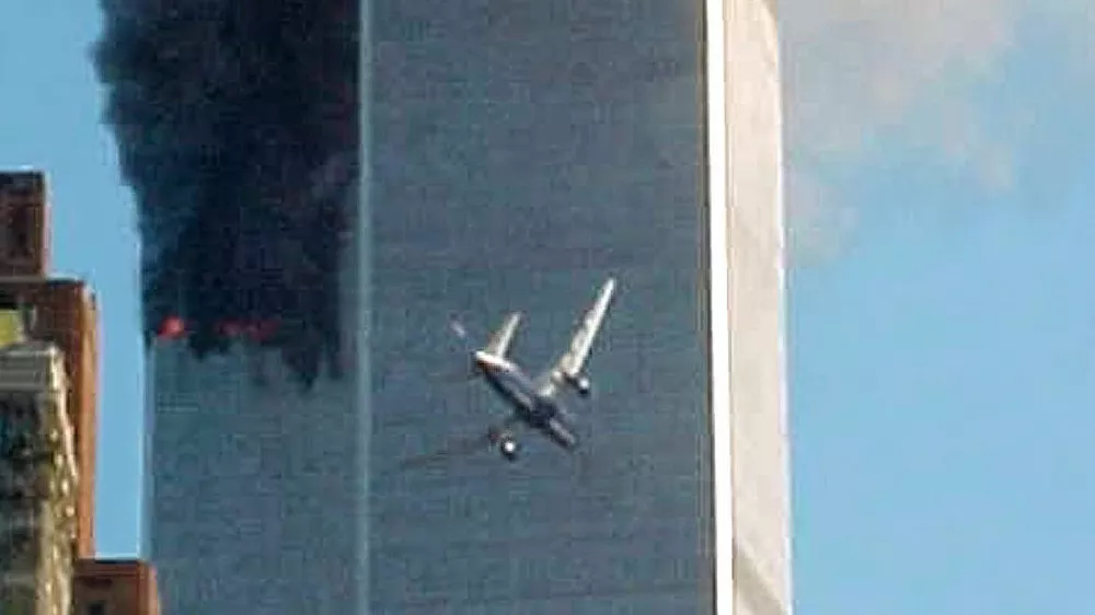 ** ADVANCE FOR TUESDAY, NOV. 4, 2008 AND THEREAFTER ** FILE ** In this Sept. 11, 2001 file photo, a jet airliner nears one of the World Trade Center towers in New York. For all of the candidates' talk about the need for change, Americans have seen plenty of it since the last time they selected a new leader - including the attack on the World trade Center in 2001. (AP Photo/Carmen Taylor/File)