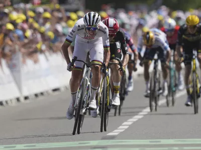 Slovenia's Tadej Pogacar sprints to the finish line to win the seventh stage of the Tour de France cycling race over 197 kilometers (122.4 miles) with start in Saint-Malo and finish in Mur-de-Bretagne Guerledan, France, Friday, July 11, 2025. (AP Photo/Thibault Camus)