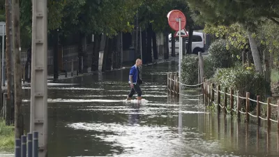 04 November 2024, Spain, Barcelona: A man tries to cross the flooded road in Castelldefels. The Service Meteorologic of Catalonia (SMC) has issued a warning for violent weather in several counties where it has decreed a maximum degree of danger. Photo: Kike Rinc&oacute;n/EUROPA PRESS/dpa