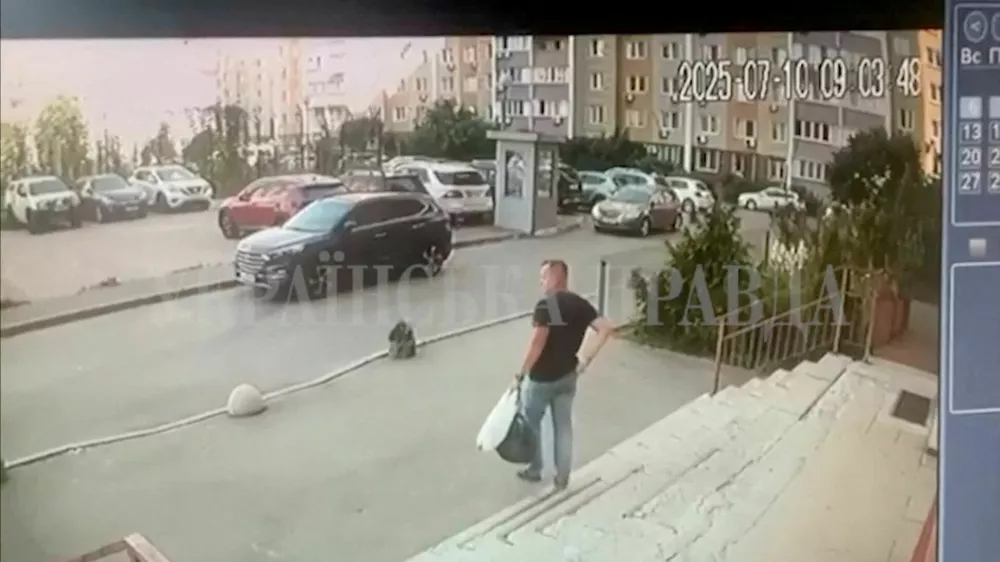 A CCTV footage shows a Security Service of Ukraine (SBU) officer walking down the stairs moments before he was shot in Kyiv, Ukraine July 10, 2025 in this screengrab obtained from a social media video. Ukrainska Pravda/via REUTERS THIS IMAGE HAS BEEN SUPPLIED BY A THIRD PARTY. MANDATORY CREDIT. UKRAINE OUT. NO COMMERCIAL OR EDITORIAL SALES IN UKRAINE. RUSSIA OUT. NO COMMERCIAL OR EDITORIAL SALES IN RUSSIA. WATERMARK FROM SOURCE. TPX IMAGES OF THE DAY VERIFICATION: - Guard box, buildings and parking lot layout matched file and satellite imagery - Date verified by timestamp and Reuters reporting