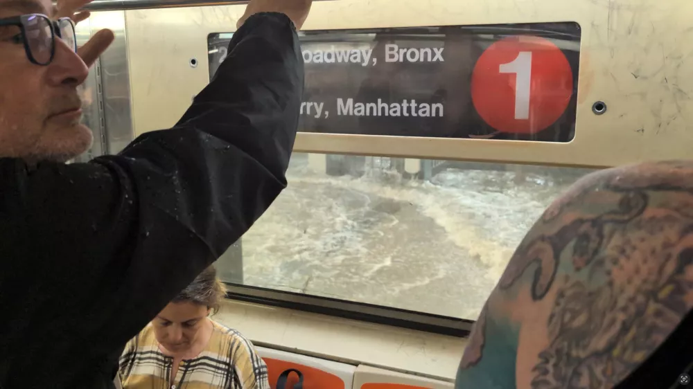 A man looks on from a subway as a station is flooded in New York, U.S., July 14, 2025, in this screengrab obtained from a social media video. Juan Luis Landaeta/via REUTERS THIS IMAGE HAS BEEN SUPPLIED BY A THIRD PARTY. MANDATORY CREDIT. NO RESALES. NO ARCHIVES.