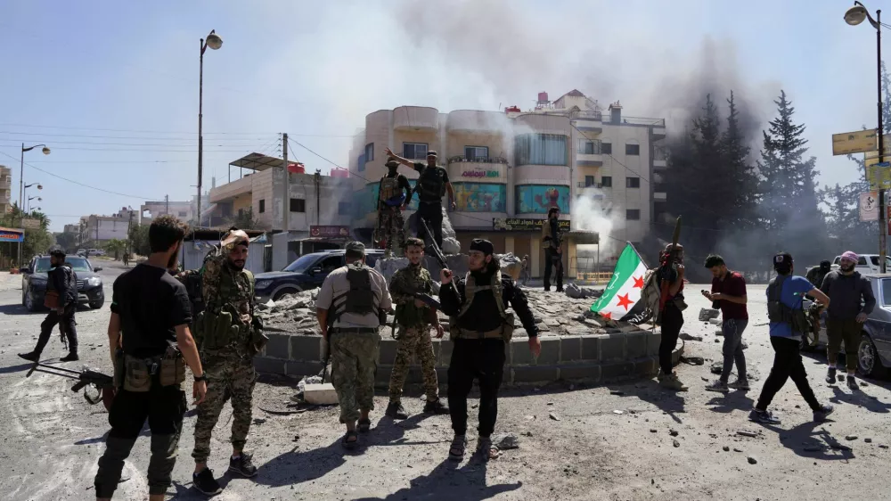 Members of Syrian security forces stand together after Syrian troops entered the predominantly Druze city of Sweida on Tuesday following two days of clashes, in Sweida, Syria July 15, 2025. REUTERS/Karam al-Masri   TPX IMAGES OF THE DAY