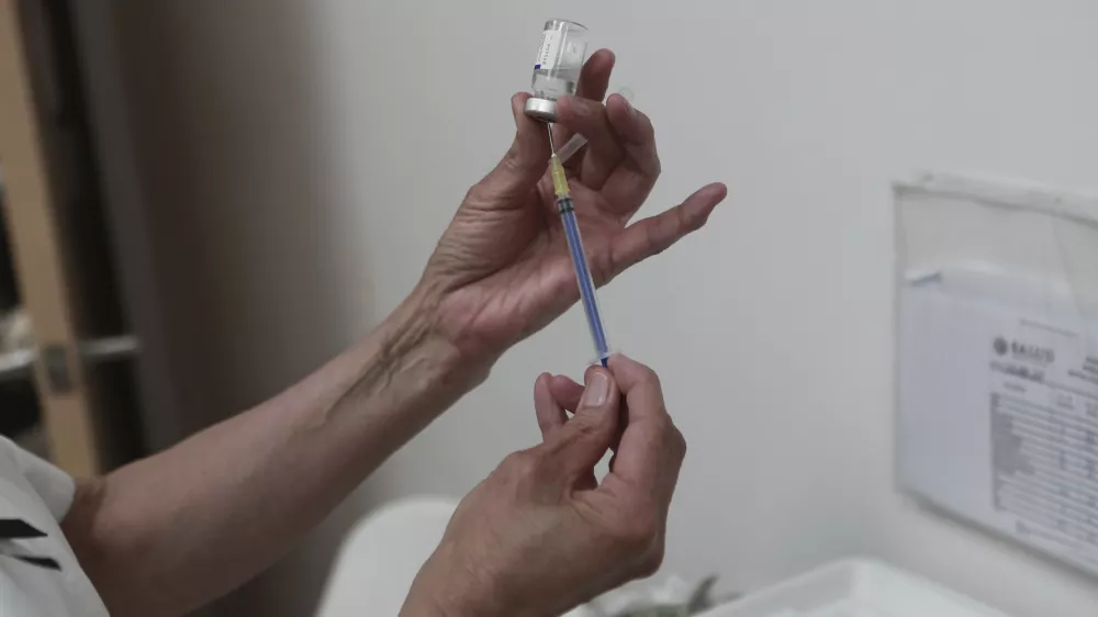 A health worker prepares a dose of the measles vaccine at the health center in Ciudad Juarez, Chihuahua state, Mexico, Wednesday, April 30, 2025. (AP Photo/Christian Chavez)