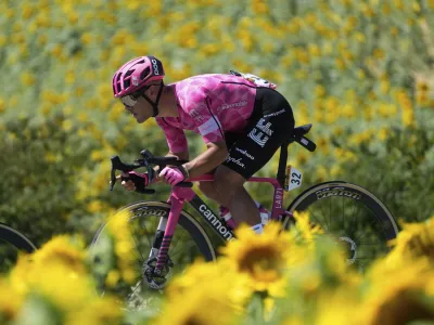 Italy's Vincenzo Albanese rides past a field of sunflowers during the eleventh stage of the Tour de France cycling race over 156.8 kilometers (97.4 miles) with start and finish in Toulouse, France, Wednesday, July 16, 2025. (AP Photo/Mosa'ab Elshamy)