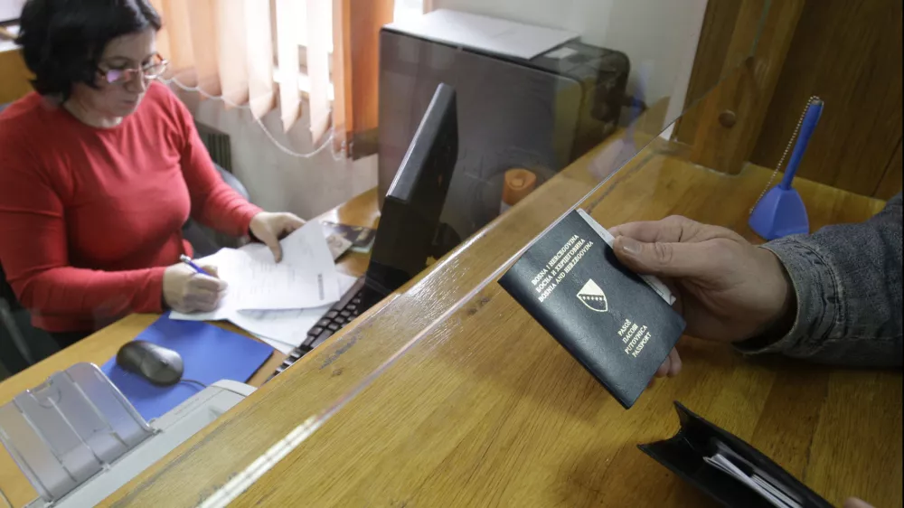 Bosnian citizen submit applications and old passport for issuing new biometric passport at police station in Sarajevo,Bosnia, on Monday, Nov. 8, 2010. European Union nations decided unanimously Monday to end visa requirements for residents of Bosnia and Albania by mid-December.The move by the EU Interior Ministers came despite fears that it will increase the number of unfounded asylum requests in the EU from the two nations. (AP Photo/Amel Emric)