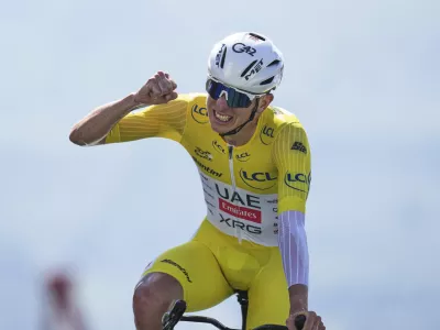 Slovenia's Tadej Pogacar, wearing the overall leader's yellow jersey, celebrates winning the thirteenth stage of the Tour de France cycling race, an individual time-trial over 10.5 kilometers (6.5 miles) in the Pyrenees mountains with start in Loudenvielle and finish in Peyragudes, France, Friday, July 18, 2025. (AP Photo/Thibault Camus)
