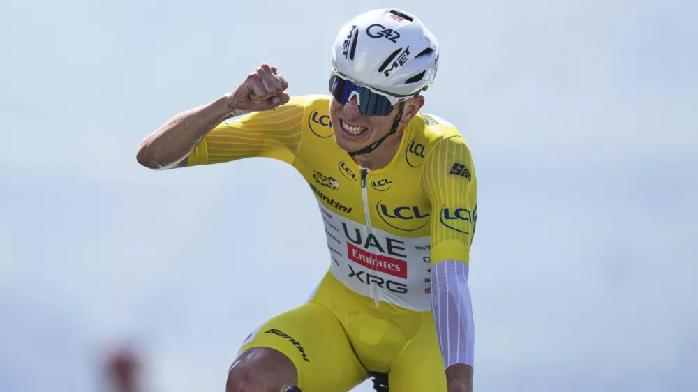 Slovenia's Tadej Pogacar, wearing the overall leader's yellow jersey, celebrates winning the thirteenth stage of the Tour de France cycling race, an individual time-trial over 10.5 kilometers (6.5 miles) in the Pyrenees mountains with start in Loudenvielle and finish in Peyragudes, France, Friday, July 18, 2025. (AP Photo/Thibault Camus)