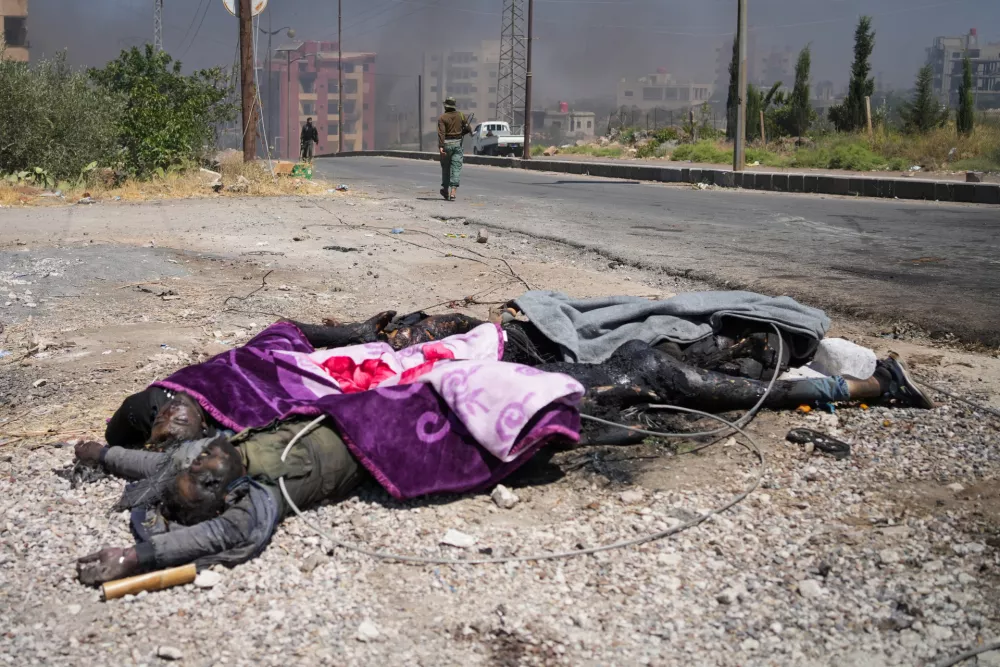 19 July 2025, Syria, As Suwayda: Bodies lie on the ground amid clashes between tribal fighters and local Druze factions in southern Syria. Fear and shock grip the province following the escalation of isolated clashes into one of the deadliest outbreaks of violence the region has witnessed in years. Photo: Moawia Atrash/dpa - ATTENTION: graphic content