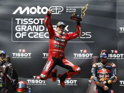 MotoGP - Czech Republic Grand Prix - Masaryk Circuit, Brno, Czech Republic - July 20, 2025 Ducati Lenovo Team's Marc Marquez celebrates with a trophy on the podium after winning the MotoGP race REUTERS/David W Cerny
