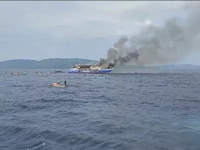 In this photo made from video released by the Indonesian National Search and Rescue Agency (BASARNAS), smoke billows from passenger ship KM Barcelona after it caught fire in the waters off Talise Island in North Sulawesi, Indonesia, Sunday, July 20, 2025. (BASARNAS via AP)