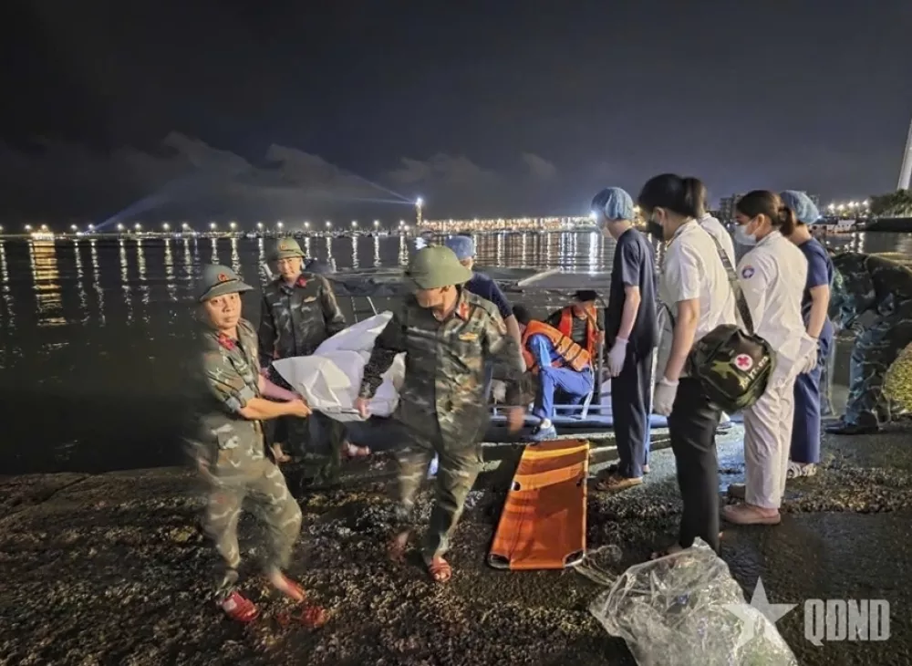 This image from a video provided by QDND shows a body being carried on stretcher after a tourist boat capsized in Ha Long Bay, Vietnam on Saturday, July 19, 2025. (QDND via AP)