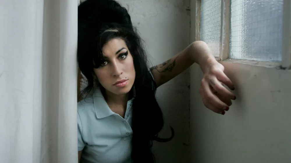 FILE - In this Feb. 16, 2007 file photo, British singer Amy Winehouse poses for a photograph at a studio in north London, Friday, Feb. 16, 2007. British police say singer Amy Winehouse has been found dead at her home in London on Saturday, July 23, 2011. The singer was 27 years old. (AP Photo/Matt Dunham, File)