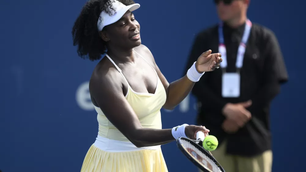 Venus Williams hits a ball toward the crowd after a doubles match with Hailey Baptiste against Eugenie Bouchard and Clervie Ngounoue at the Citi Open tennis tournament Monday, July 21, 2025, in Washington. (AP Photo/Nick Wass)