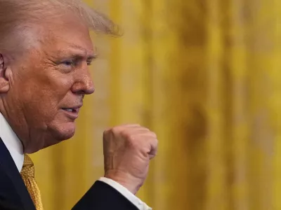 President Donald Trump raises his fist after speaking during a reception for Republican members of Congress in the East Room of the White House, Tuesday, July 22, 2025, in Washington. (AP Photo/Julia Demaree Nikhinson)