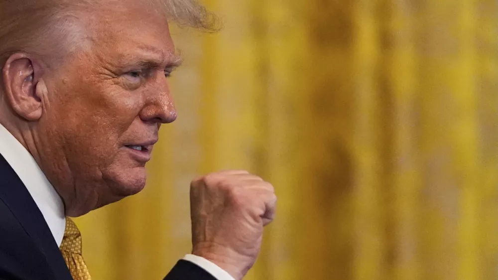 President Donald Trump raises his fist after speaking during a reception for Republican members of Congress in the East Room of the White House, Tuesday, July 22, 2025, in Washington. (AP Photo/Julia Demaree Nikhinson)