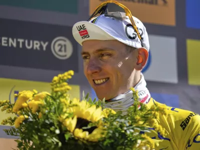 Slovenia's Tadej Pogacar, wearing the overall leader's yellow jersey, celebrates on the podium after sixteenth stage of the Tour de France cycling race over 171.5 kilometers (106.6 miles) with start in Montpellier and finish on the Mont Ventoux, France, Tuesday, July 22, 2025. (AP Photo/Mosa'ab Elshamy)