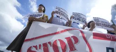 Members of civic groups protest against U.S. President Donald Trump's tariffs policy on South Korea, near the U.S. embassy in Seoul, South Korea, Tuesday, July 22, 2025. The banners reads " The U.S. should stop raising unfair tariffs and pressuring for increased military spending."(AP Photo/Ahn Young-joon)