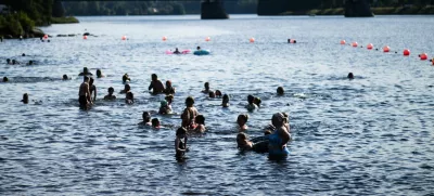 People enjoy the warm weather at the Ounaskoski Beach in Rovaniemi, Finland, July 23, 2025.  Lehtikuva/Jouni Porsanger/via REUTERS   ATTENTION EDITORS - THIS IMAGE WAS PROVIDED BY A THIRD PARTY. NO THIRD PARTY SALES. NOT FOR USE BY REUTERS THIRD PARTY DISTRIBUTORS. FINLAND OUT. NO COMMERCIAL OR EDITORIAL SALES IN FINLAND.