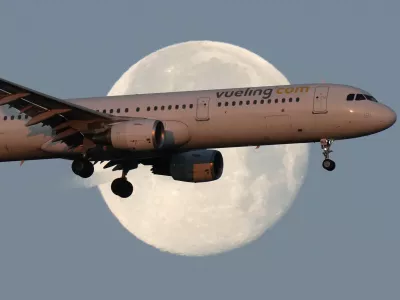 FILE - A Vueling Airbus A321 approaches for landing in Lisbon at sunrise, while the moon sets in the background,, Feb. 7, 2023. (AP Photo/Armando Franca, File)