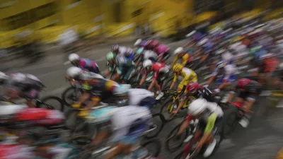 The pack with Slovenia's Tadej Pogacar, wearing the overall leader's yellow jersey, rides during the twenty-first stage of the Tour de France cycling race over 132.3 kilometers (82.1 miles) with start in Mantes-la-Ville and finish on the Champs-Elysees in Paris, France, Sunday, July 27, 2025. (AP Photo/Thibault Camus)