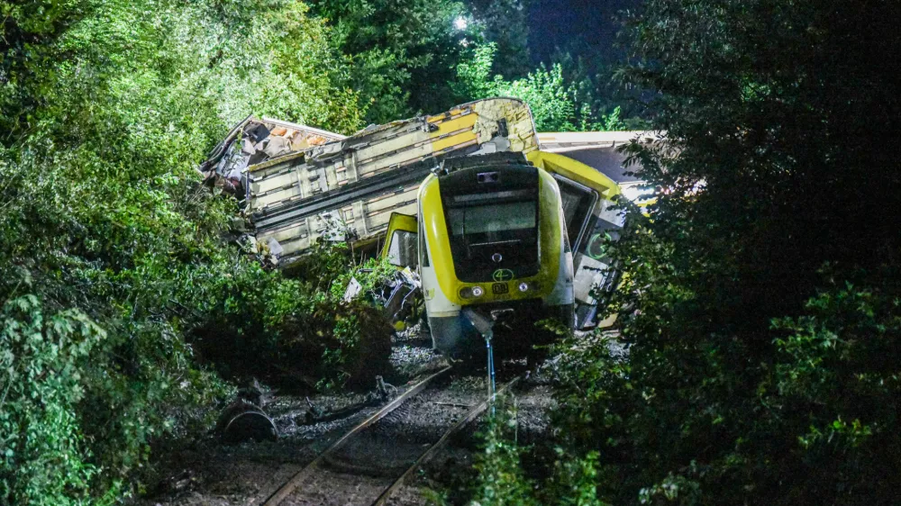 Wagons of a derailed regional passenger train lie on a railroad line near Riedlingen, Germany, early Monday, July 28, 2025. (dpa via AP)