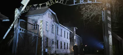 Britain's King Charles walks past the 'Arbeit Macht Frei' gate during a visit to Auschwitz, following commemorations to mark 80 years since the liberation of the Nazi German concentration and extermination camp, in Poland January 27, 2025. Victoria Jones/Pool via REUTERS