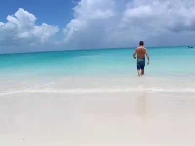 Man walking into ocean