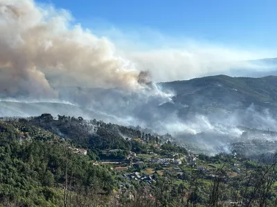 Smoke from a wildfire rises over the hills near the village of Canelas, Arouca region, Portugal, July 29, 2025. REUTERS/Miguel Pereira