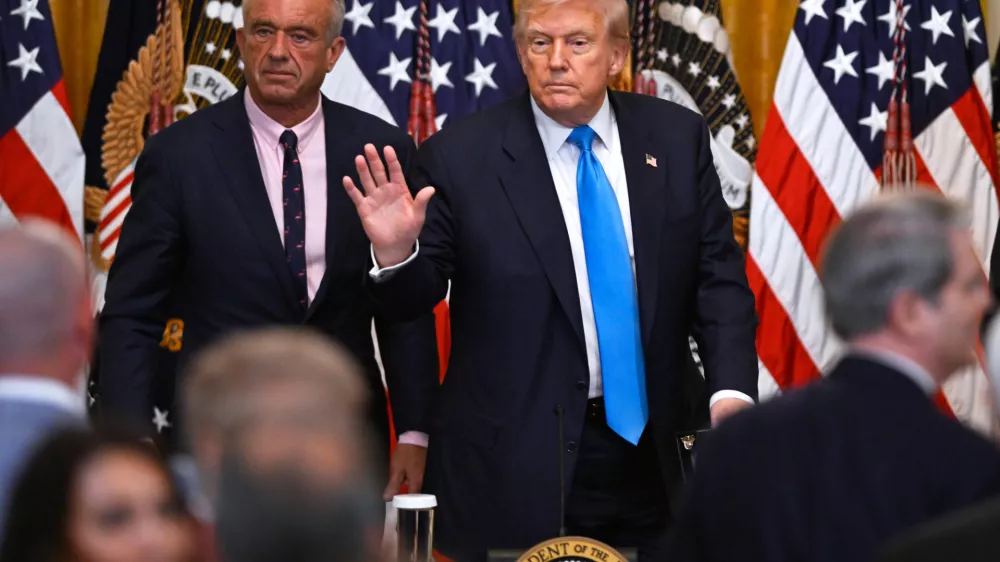 President Donald Trump and Health and Human Service Secretary Robert F. Kennedy, Jr., left, depart after speaking at an event in the East Room of the White House, Wednesday, July 30, 2025, in Washington. (AP Photo/John McDonnell)