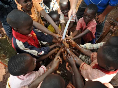 Maga Maga, city in Mayuge District, Uganda, Africa - August 1, 2017: Children at an orphanage in Uganda are happy with a new solar water pump that brings needed water to their living area. A new solar pump, built by Engineers Without Borders, can pump three gallons a minute using the sun as the power source. The pump was delivered by missionaries and doctors from the U.S.A.