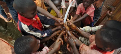 Maga Maga, city in Mayuge District, Uganda, Africa - August 1, 2017: Children at an orphanage in Uganda are happy with a new solar water pump that brings needed water to their living area. A new solar pump, built by Engineers Without Borders, can pump three gallons a minute using the sun as the power source. The pump was delivered by missionaries and doctors from the U.S.A.