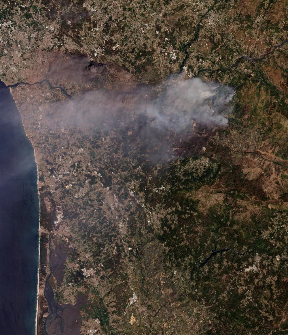A satellite view shows smoke following the wildfire in Porto, Portugal, July 30, 2025. Planet Labs PBC/Handout via REUTERS  THIS IMAGE HAS BEEN SUPPLIED BY A THIRD PARTY. MANDATORY CREDIT.