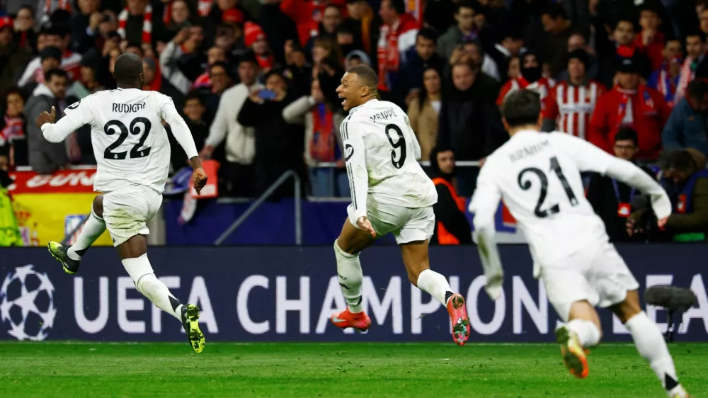 FILE PHOTO: Soccer Football - Champions League - Round of 16 - Second Leg - Atletico Madrid v Real Madrid - Metropolitano, Madrid, Spain - March 12, 2025 Real Madrid's Kylian Mbappe and Antonio Rudiger celebrate after the match REUTERS/Susana Vera/File Photo