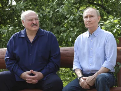 Russian President Vladimir Putin, right, and Belarusian President Alexander Lukashenko sit on a bench during their visit to the Smolensky Skete of Valaam Monastery at Valaam island in Ladoga lake, Republic of Karelia, Russia, Friday, Aug. 1, 2025. (Gavriil Grigorov, Sputnik, Kremlin Pool Photo via AP)