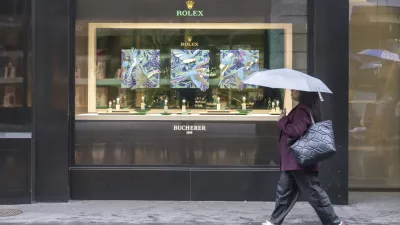 A woman walks by a store selling Rolex watches, on Grendelstrasse, Wednesday, April 16, 2025 in Lucerne, Switzerland. (Urs Flueeler/Keystone via AP)