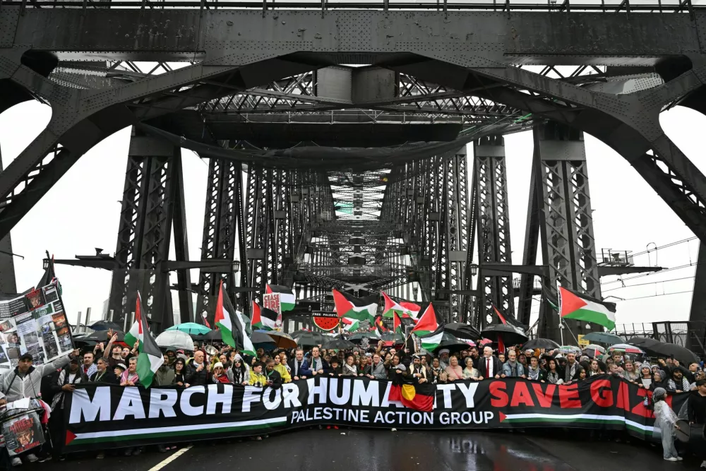 Protesters walk across the Sydney Harbour Bridge during the Palestine Action Group's March for Humanity in Sydney, Australia, August 3, 2025. AAP/Dean Lewins via REUTERS  ATTENTION EDITORS - THIS IMAGE WAS PROVIDED BY A THIRD PARTY. NO RESALES. NO ARCHIVE. AUSTRALIA OUT. NEW ZEALAND OUT. NO COMMERCIAL OR EDITORIAL SALES IN NEW ZEALAND. NO COMMERCIAL OR EDITORIAL SALES IN AUSTRALIA.