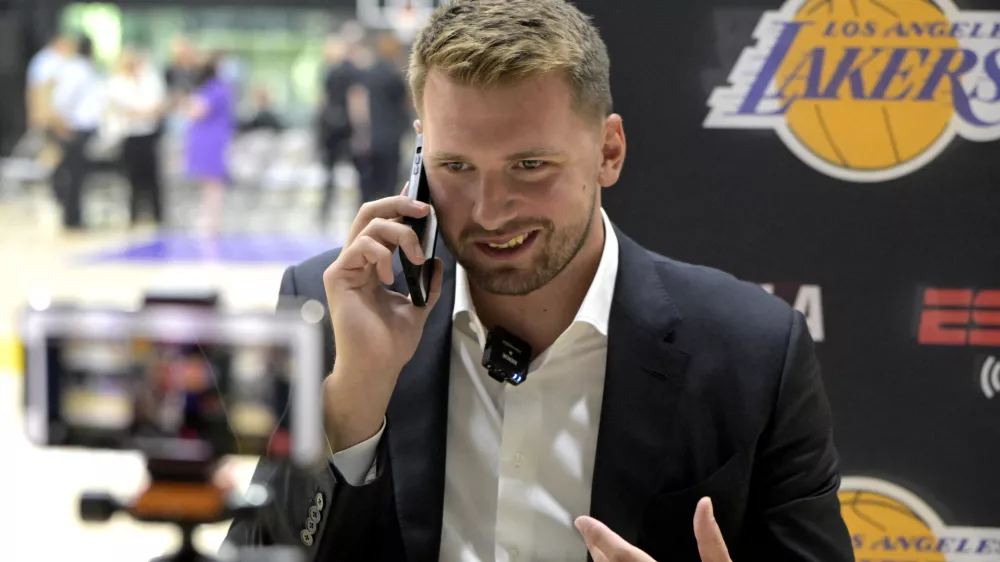 Aug 2, 2025; El Segundo, CA, USA; Los Angeles Lakers Luka Doncic (77) is interviewed by ESPN LA radio following a press conference announcing the signing of a 3-year, $165 million contract extension at UCLA Health Training Center. Mandatory Credit: Jayne Kamin-Oncea-Imagn Images