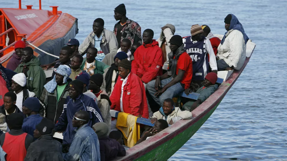Would-be immigrants arrive at the port of Santa Cruz de Tenerife in Spain's Canary island of Tenerife June 10, 2007. Some 135 would-be immigrants were intercepted aboard a fishing boat on their way to reach European soil from Africa, according to authorities.REUTERS/Juan Medina (SPAIN)