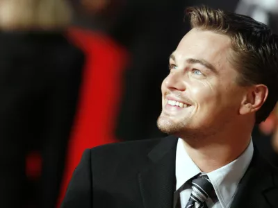 ** ALTERNATIVE CROP ** Actor Leonardo Di Caprio smiles as he arrives at Rome's Auditorium, Sunday, Oct. 15, 2006, to present the movie "The Departed," at the first ever edition of the Rome Film Festival. (AP Photo/Andrew Medichini)
