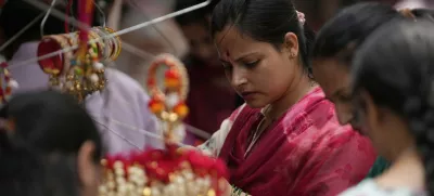 A woman shops for 'Rakhi,' the sacred thread symbolizing sibling bonds, ahead of the Raksha Bandhan festival in Jammu, India, Monday, Aug 4, 2025.(AP Photo/Channi Anand)