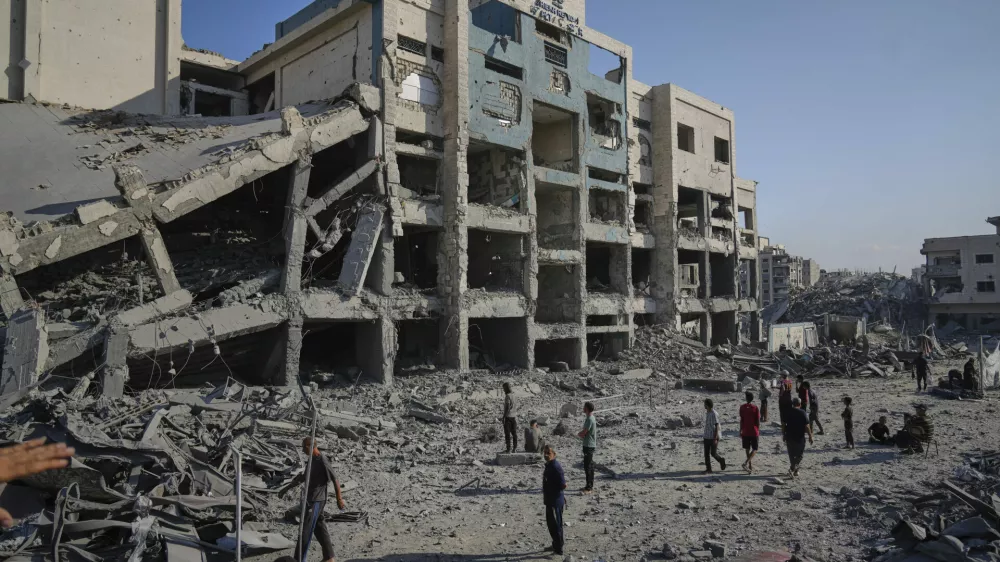 People inspect the damage at the Sheikh Radwan al-Taba UNRWA clinic following an Israeli army bombardment in Gaza City Wednesday, Aug. 6, 2025. The clinic had been evacuated of displaced Palestinians prior to the strike. (AP Photo/Jehad Alshrafi)