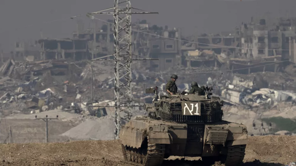 FILE - Israeli soldiers overlook the Gaza Strip from a tank, as seen from southern Israel, on Friday, Jan. 19, 2024. (AP Photo/Maya Alleruzzo, File)