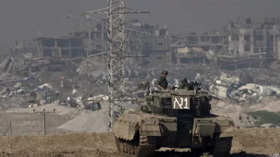 FILE - Israeli soldiers overlook the Gaza Strip from a tank, as seen from southern Israel, on Friday, Jan. 19, 2024. (AP Photo/Maya Alleruzzo, File)