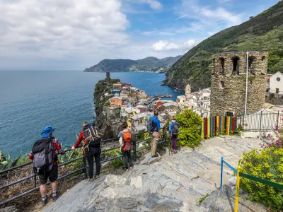Vernazza, Italy - May 2, 2019 People tourists ingoing the view at Vernazza village and Cinque Terre coastal area from the Trial Sentiero Azzuro. Liguria, Italy.