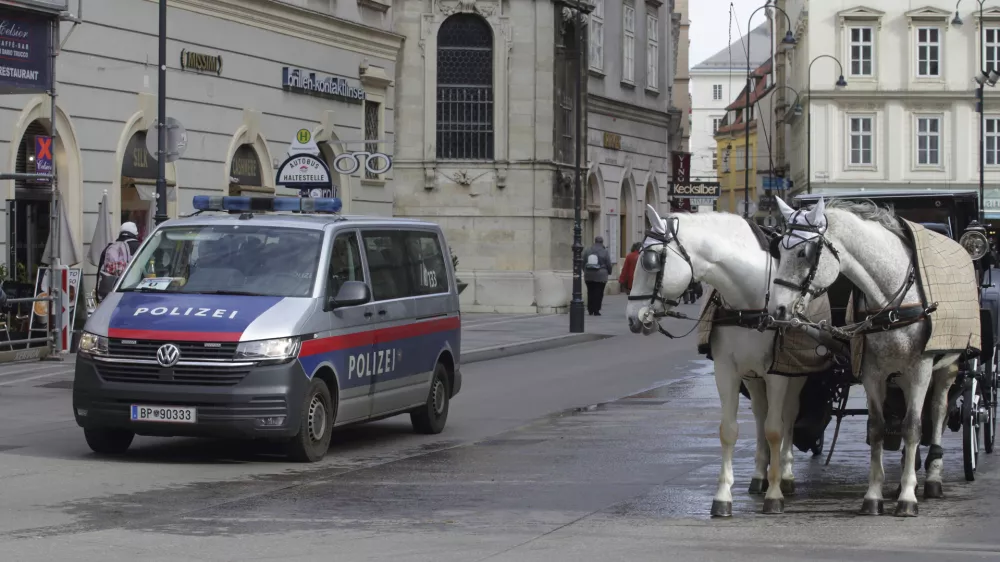 A police van drives past Fiaker horses at St. Stephen's cathedral in Vienna, Austria, Wednesday, Mar 15, 2023. Austrian police are warning of a possible "Islamist-motivated attack" targeting churches in Vienna. They cited undisclosed information the country's intelligence service had received. (AP Photo/Heinz-Peter Bader)