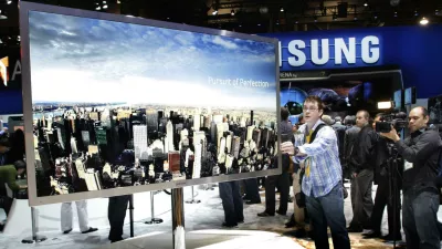 A reporter touches a 75-inch, full HD 3D LED television by Samsung Electronics during the first day of the 2011 International Consumer Electronics Show (CES) in Las Vegas, Nevada January 6, 2011. REUTERS/Steve Marcus (UNITED STATES - Tags: BUSINESS)
