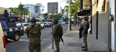 Members of the federal forces operate near a business closed and put up for rent, as violence and economic turmoil escalate in Culiacan one year after the abduction and extradition of Sinaloa Cartel leader Ismael "El Mayo" Zambada to the United States, in Culiacan, Sinaloa state, Mexico, July 24, 2025. REUTERS/Fernando Brito