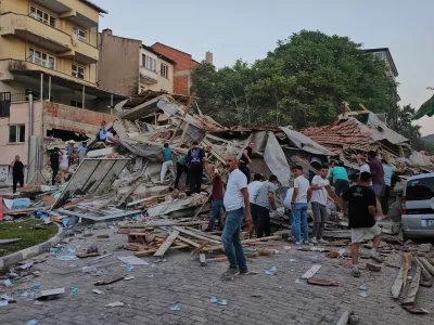 People remove the wreckage of a collapsed building following an earthquake in Sindirgi, northwest Turkey, Sunday, Aug. 10, 2025. (Bahadir Demirceviren/IHA via AP)
