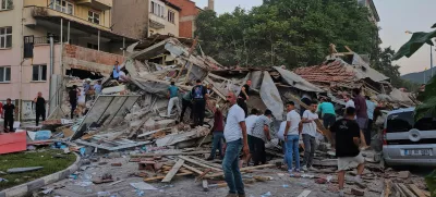 People remove the wreckage of a collapsed building following an earthquake in Sindirgi, northwest Turkey, Sunday, Aug. 10, 2025. (Bahadir Demirceviren/IHA via AP)