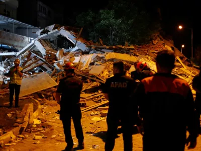 Search and rescue teams stand next to a collapsed building after an earthquake in Sindirgi, in the western Balikesir province, Turkey, August 11, 2025. REUTERS/Efekan Akyuz   TPX IMAGES OF THE DAY